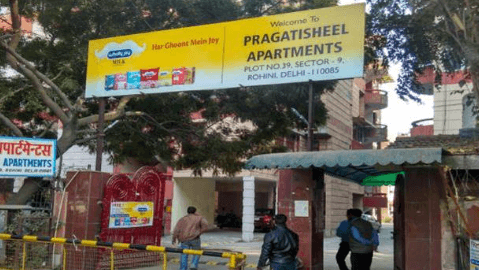Residential community entrance showcasing Society Gate Branding with an RWA Society Gate Branding board installed professionally.