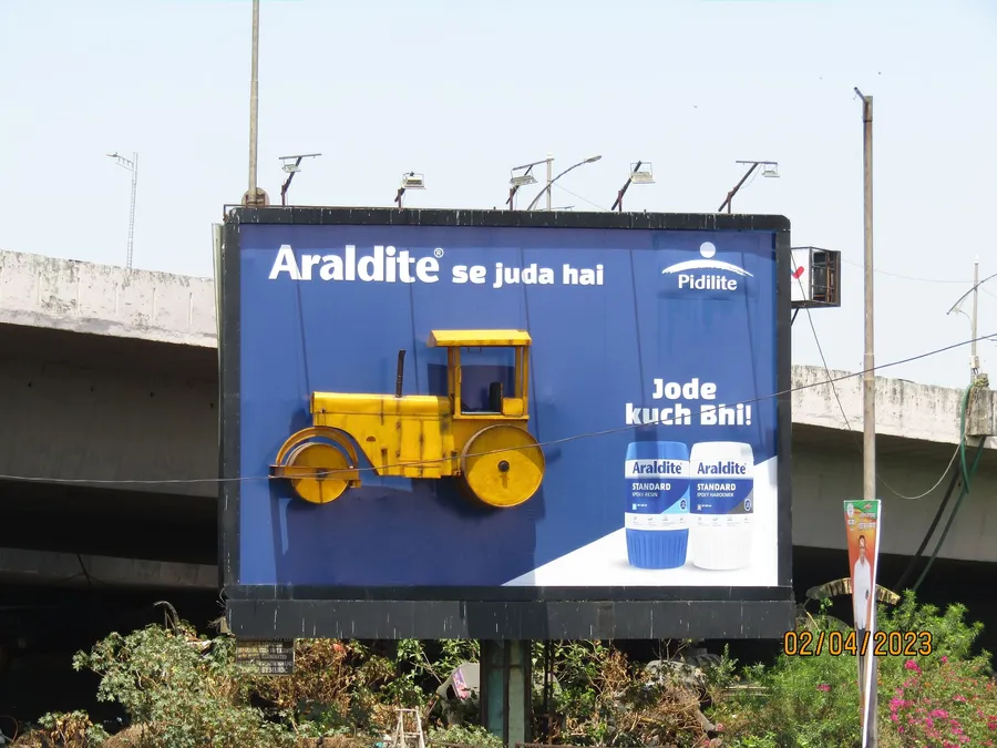 Outdoor advertisement showcasing a creative billboard design in a roadside location