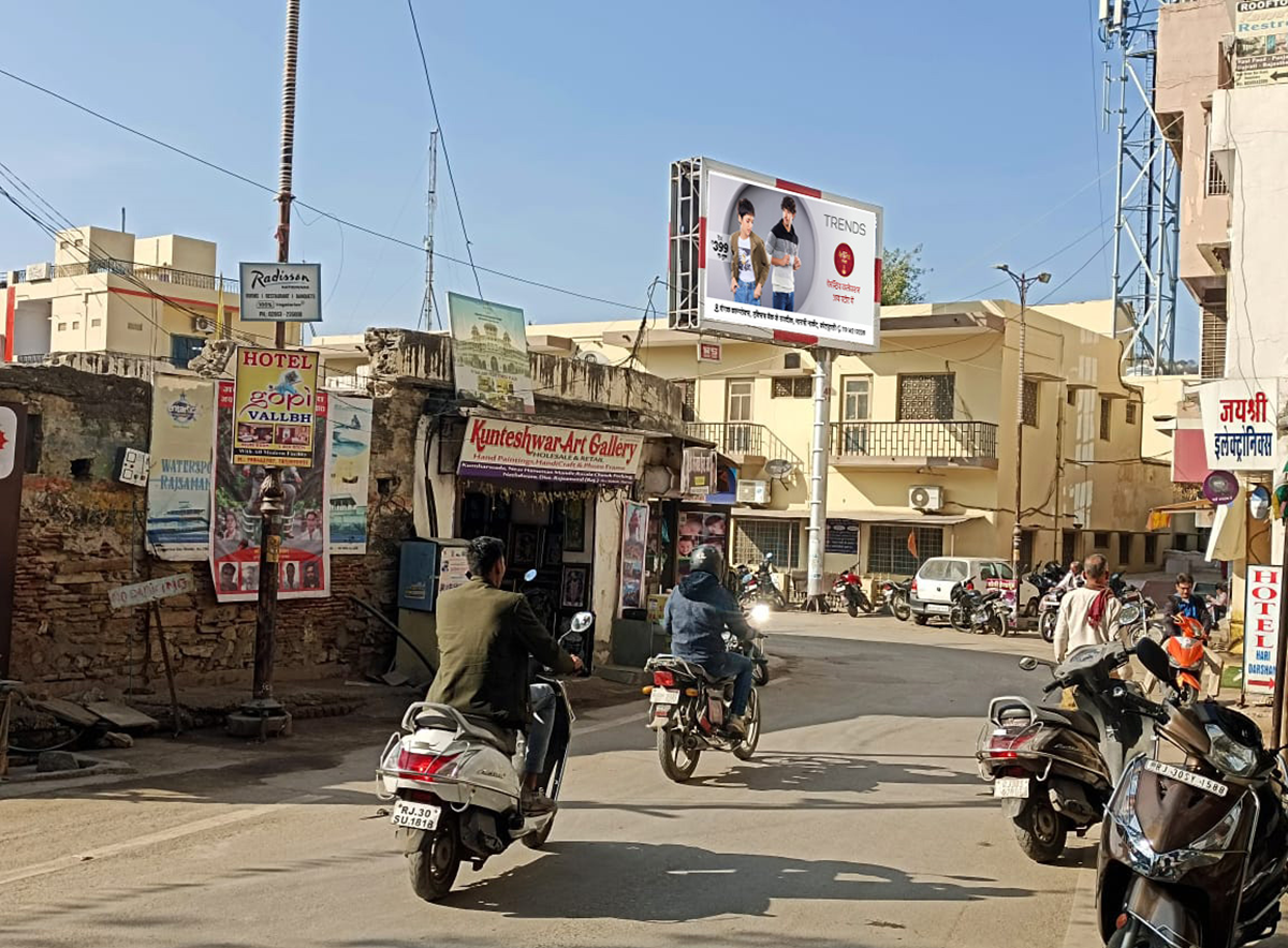 Large roadside billboard in Rajasthan displaying a vibrant brand advertisement, placed in a high-traffic urban area, showcasing the work of leading billboard advertising companies in Rajasthan.