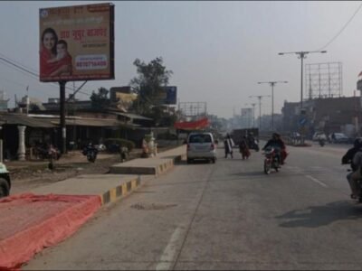 Billboard installed by hoarding advertising companies in Lucknow on a busy urban street with passing vehicles and pedestrians ideal for hyperlocal ads.