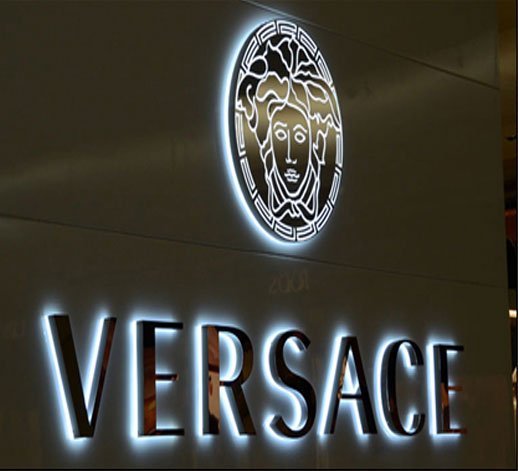 Illuminated Versace signage board with Medusa logo in retail store