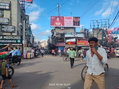 Aminabad Market street view in Lucknow with pedestrians, shops, and unipole advertising spaces by top Unipole advertising company in Lucknow.