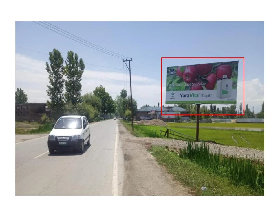 YaraVita Stopit billboard in rural roadside scene ACME Advertising Co., top billboard advertising companies in Jammu & Kashmir, promotes fruit quality branding.