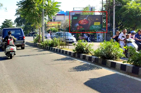 "Urban street in Jammu and Kashmir with 20x10 ft food hoarding by ACME Advertising Co., featuring bowl visual and ₹10.4 value message; visible car, scooter, pedestrians, greenery, and digital billboard.