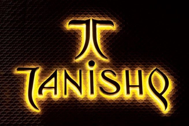 Tanishq jewelry brand illuminated logo showcasing elegant signages board advertising at night