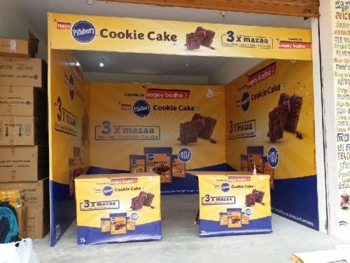 Indoor retail promotion booth with branded panels and product displays for packaged food marketing.